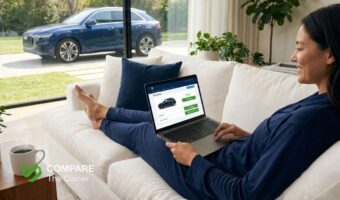 Woman sitting on sofa at home choosing a car online on laptop