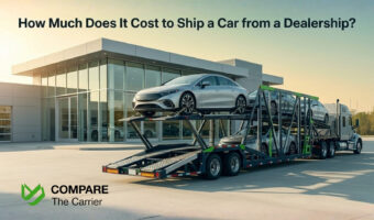 A silver modern sedan being loaded onto an auto transport trailer outside a luxury car dealership at sunrise.