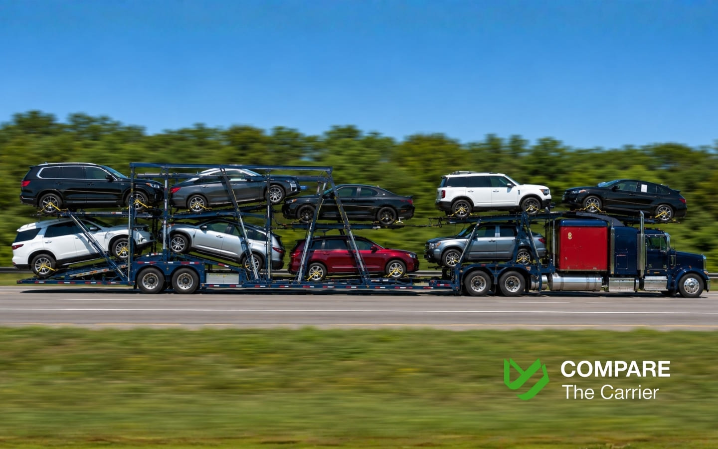 Open car hauler truck transporting American vehicles on a highway in a tandem configuration.